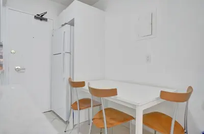 a kitchen with a white table and two chairs at Resort beach condo w beach service 601 in Miami Beach
