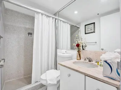 a bathroom with a toilet and a sink and a shower at Lovely Ocean View Condo Beach Service 704 in Miami Beach