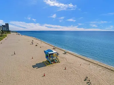 a beach with a life guard stand and people on it at Lovely Ocean View Condo Beach Service 704 in Miami Beach