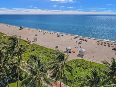 an aerial view of a beach with palm trees and the ocean at Spacious Ocean View Condo Beach Service 803 in Miami Beach