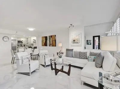 a living room with white couches and a table at Luxury Beachfront Condo Beach Service 1418 in Miami Beach
