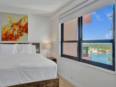 a bedroom with a bed and a large window at Luxury Ocean View Condo Beach and Resort 1216 in Miami Beach