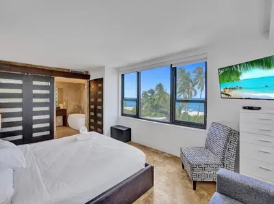 a bedroom with a bed and a view of the ocean at Luxury Full Ocean View Condo Resort Amenities 501 in Miami Beach