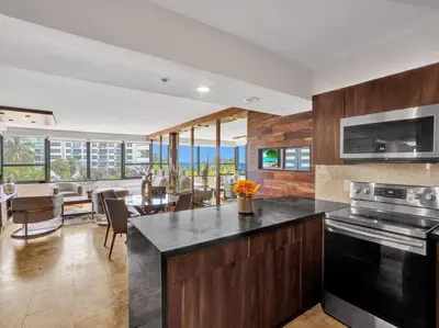 a kitchen and dining room with a view of the ocean at Luxury Full Ocean View Condo Resort Amenities 501 in Miami Beach