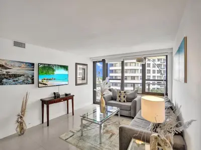 a living room with a couch and a table at Spacious Ocean View Condo Beach Service 509 in Miami Beach