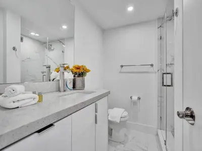 a white bathroom with a shower and a sink at Ocean View Retreat Beach Service 1603 in Miami Beach