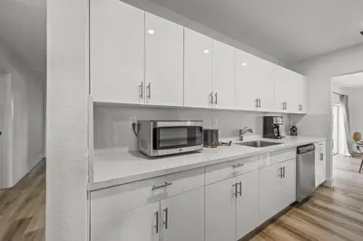 a kitchen with white cabinets and a microwave at Tulum Villa in Miami