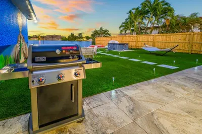 a backyard with a grill and a yard with a lawn sidx sidx at Tulum Villa in Miami