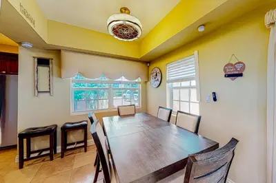 a dining room with a wooden table and chairs at Go with the Flow in Hollywood