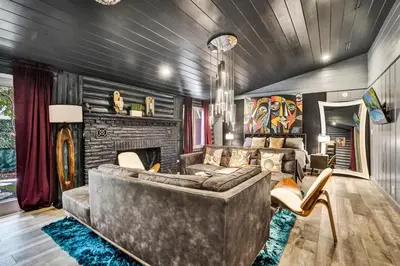 a living room with a couch and a fireplace at Kiki Grand Suite - Men's Clothing optional Guest Houses in Fort Lauderdale