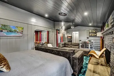 a bedroom with a bed and a couch at Kiki Grand Suite - Men's Clothing optional Guest Houses in Fort Lauderdale