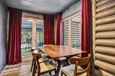 a dining room with a wooden table and chairs at Kiki Grand Suite - Men's Clothing optional Guest Houses in Fort Lauderdale