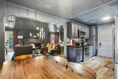 a kitchen and living room with a table and chairs at Kiki Grand Suite - Men's Clothing optional Guest Houses in Fort Lauderdale