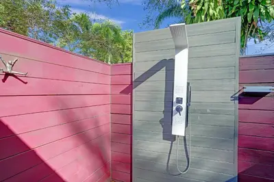 a metal gate with a hose attached to a fence at Kiki 1 - Men's Clothing optional Guest Houses in Fort Lauderdale