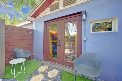 a blue house with two chairs and a door at Kiki 2 - Men's Clothing optional Guest Houses in Fort Lauderdale