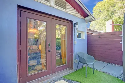 a door with a chair in front of a house at Kiki 2 - Men's Clothing optional Guest Houses in Fort Lauderdale