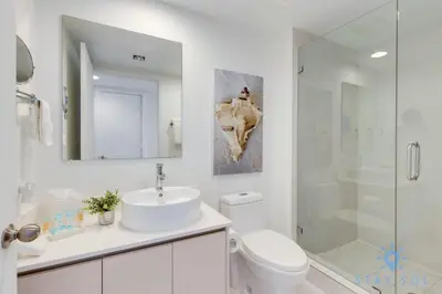 a bathroom with a sink and a toilet and a shower at Infinite View Balcony Gym Amaizing Pool in Hallandale Beach