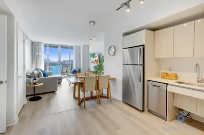 a kitchen and living room with a table and chairs at Amaizing Pool Infinity View w Balcony Gym in Hallandale Beach