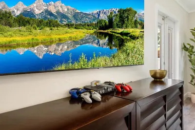 a painting of a mountain lake on a wall at Palms Retreat! Giant Heated Pool-HotTub-FirePit-5Min2Beach-Pets-EV Chgr in Fort Lauderdale
