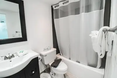 a bathroom with a sink and a toilet and a mirror at Castle 1118 Studio BayView Direct Beach Access, Tennis, Pool, Restaurants, Free Parking in Miami Beach