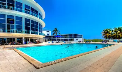 a large swimming pool in front of a building at Castle 618 in Miami Beach