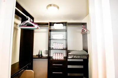 a walk in closet with shoes on the shelves at Castle 618 in Miami Beach