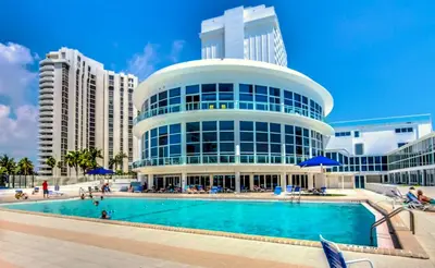 a large building with a swimming pool in front of it at Castle 618 in Miami Beach