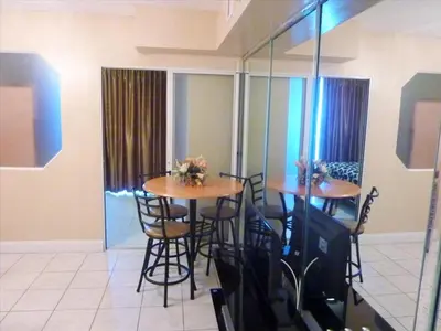 a dining room with two tables and some chairs at Castle 727 Studio with balcony and Ocean view, Pool, Tennis, Beach Access, Free Parking in Miami Beach