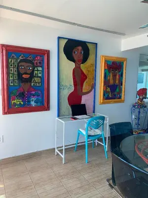a room with a desk and paintings on the wall at Castle BTH2 Stunning Oceanfront Townhouse, Private Beach Access, Private Pool Access, Tennis and Free Parking! in Miami Beach