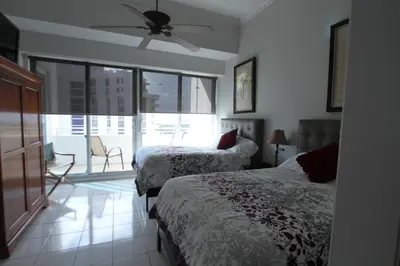 a bedroom with two beds and a ceiling fan at Castle PH12 Spacious Bay View Penthouse, Pool, Tennis, Free Parking in Miami Beach