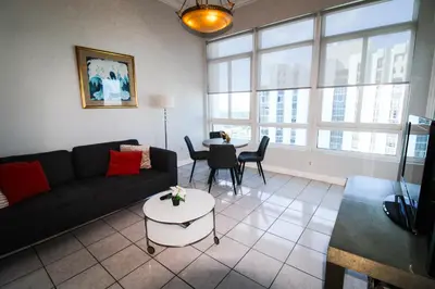 a living room with a couch and a table at Castle PH12 Spacious Bay View Penthouse, Pool, Tennis, Free Parking in Miami Beach