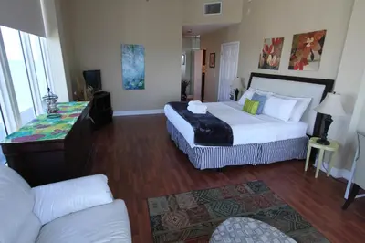 a hotel room with two beds and a couch at Castle PH15 Spacious Penthouse with Balcony, Beach Access, Pool, Tennis, Free Parking in Miami Beach