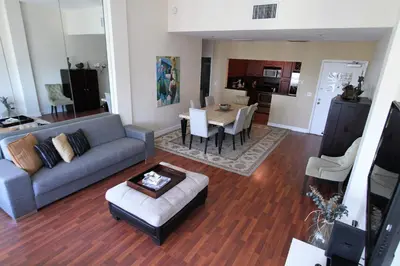 a living room with a couch and a table at Castle PH15 Spacious Penthouse with Balcony, Beach Access, Pool, Tennis, Free Parking in Miami Beach