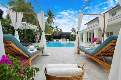 a villa with a swimming pool and a patio at MIA MANSION W/ POOL / BBQ /CABANNA / OUTDOOR BAR in Tamiami