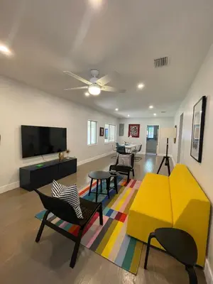 a living room with a couch and chairs and a tv at Best location Miami Brickell 3 bedroom Home in Miami