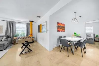 a dining room and living room with a table and chairs at New Tropical Oasis Retreat in Miami in Miami