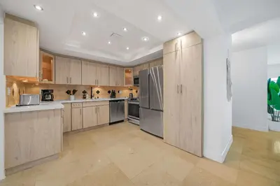 a large kitchen with wooden cabinets and stainless steel appliances at New Tropical Oasis Retreat in Miami in Miami