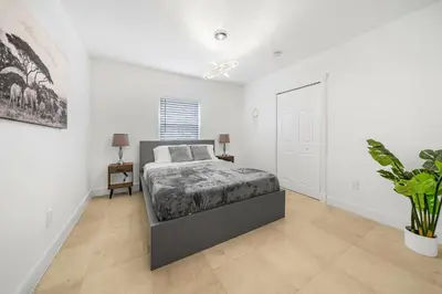 a bedroom with a bed and a plant in it at New Tropical Oasis Retreat in Miami in Miami