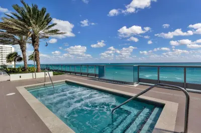 a swimming pool with a view of the ocean at Dharma Home Suites Miami Beach at Monte Carlo in Miami Beach