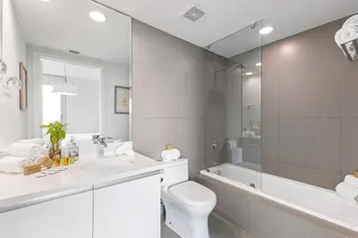 a bathroom with a sink and a toilet and a tub at Dharma Home Suites Miami Beach at Monte Carlo in Miami Beach