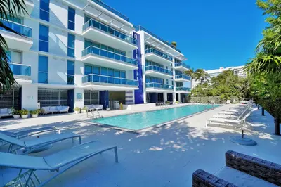 a swimming pool in front of a building at Dharma Home Suites Miami Beach at Monte Carlo in Miami Beach