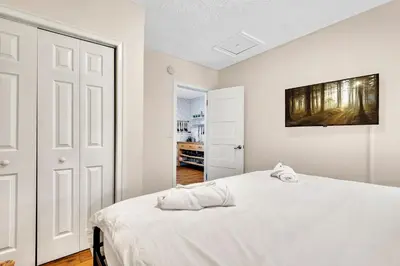 a white bedroom with a bed and a painting on the wall at Casa Del Rio 4 Bed 2 Bath Next to River 1826 in Miami