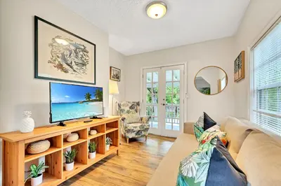 a living room with a tv and a couch at Casa Del Rio 4 Bed 2 Bath Next to River 1826 in Miami