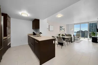 a kitchen and dining room with a view of a table at ICON W BRICKELL BY IMD MIAMI Splendid Ocean View 2BR 1BA in Miami