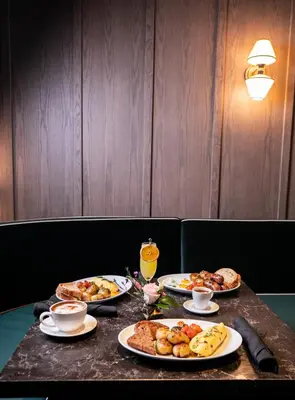 a table with several plates of food on it at Gale Miami Hotel & Residences in Miami