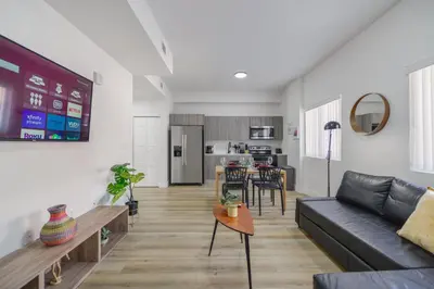 a living room with a couch and a table at Charming Apt Near to Stadium LoanDepot Park in Miami
