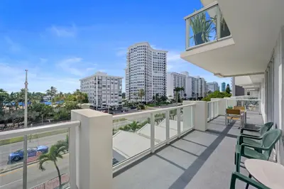 a balcony with chairs and a view of the city at Pavilion Residences on the Beach in Miami Beach