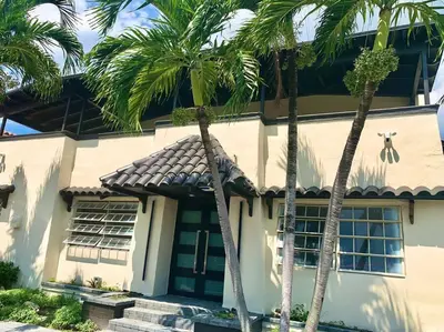 a house with palm trees in front of it at New Miami Boutique, by Calle Ocho and South Beach! in Miami