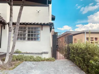a white house with a gate in a yard at New Miami Boutique, by Calle Ocho and South Beach! in Miami