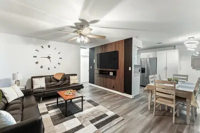 a living room with a couch and a dining room at Sunrise Getaway in Sunrise